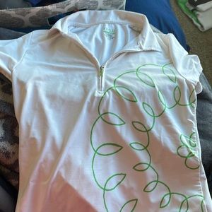 White golf shirt with a green flower design